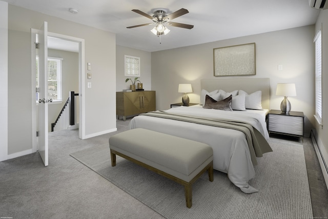 carpeted bedroom with ceiling fan and a wall mounted AC