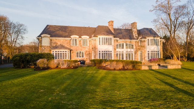 rear view of house with a yard