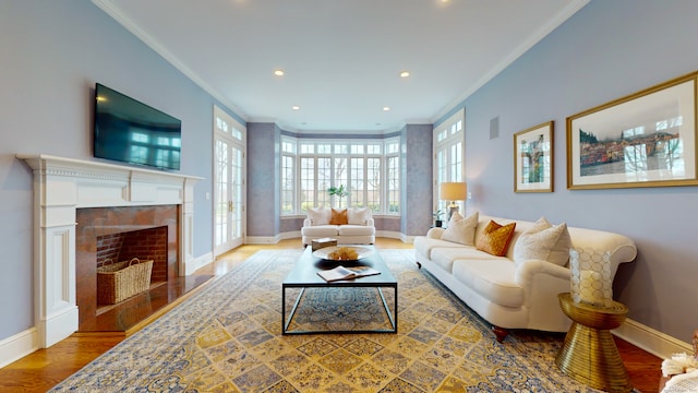 living room featuring crown molding, wood-type flooring, and a tile fireplace