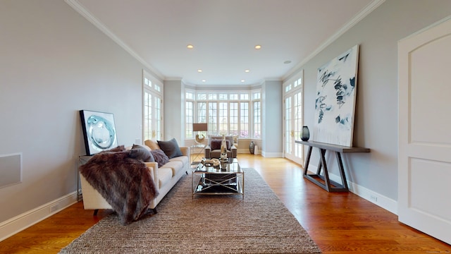 living room with crown molding and hardwood / wood-style floors