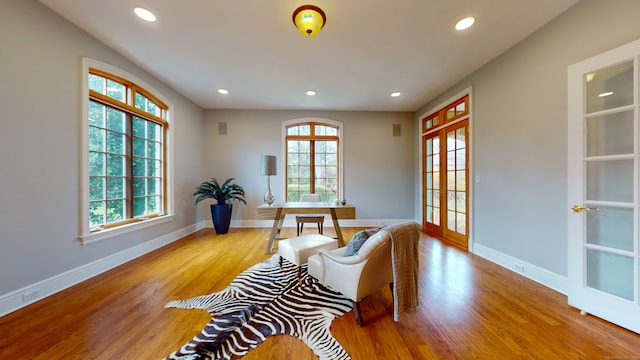 sitting room with french doors and light wood-type flooring