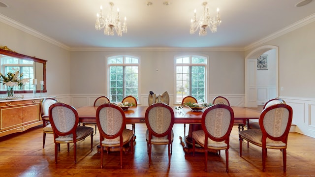 dining room with ornamental molding, a chandelier, and dark wood-type flooring