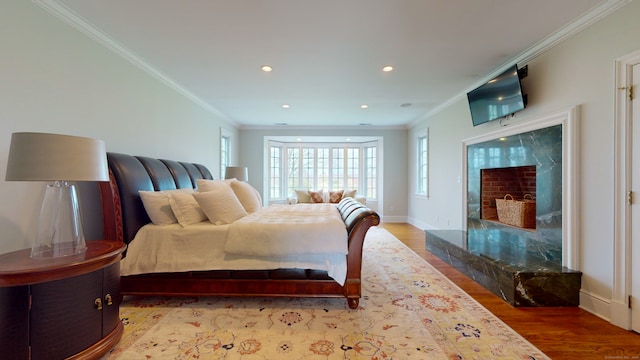 bedroom with hardwood / wood-style flooring and crown molding