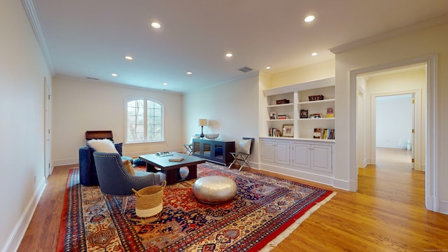 dining space featuring light hardwood / wood-style floors, built in features, and ornamental molding