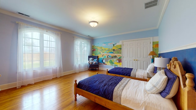 bedroom featuring crown molding and light wood-type flooring