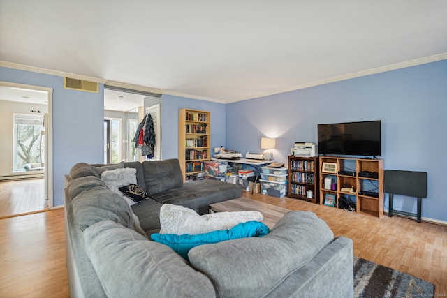 living room with a baseboard radiator, light hardwood / wood-style floors, and crown molding