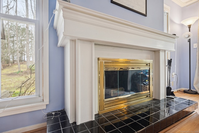 interior details with crown molding and hardwood / wood-style flooring