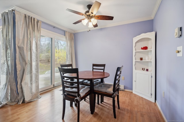 dining room with crown molding, light hardwood / wood-style flooring, and ceiling fan