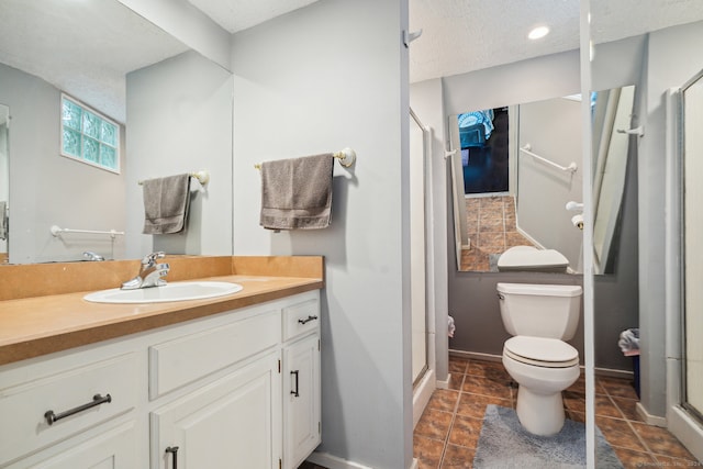 bathroom featuring a textured ceiling, large vanity, toilet, and tile flooring