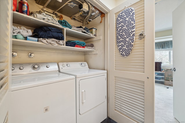 clothes washing area with separate washer and dryer