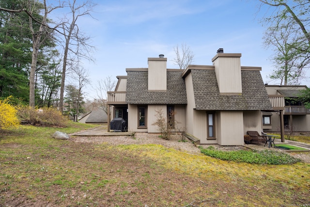 back of house with a lawn and a patio area