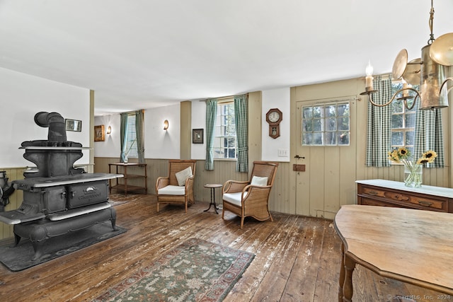 sitting room featuring dark wood-type flooring and a wood stove