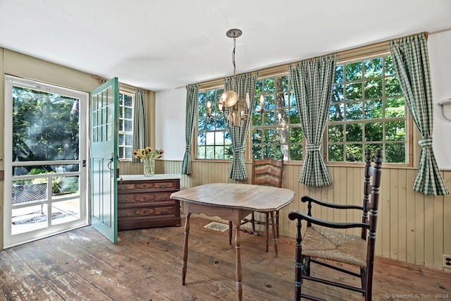 dining space with a notable chandelier, dark hardwood / wood-style floors, and a wealth of natural light