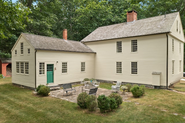 back of house featuring a yard and a patio