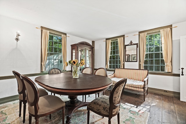 dining space with dark hardwood / wood-style floors