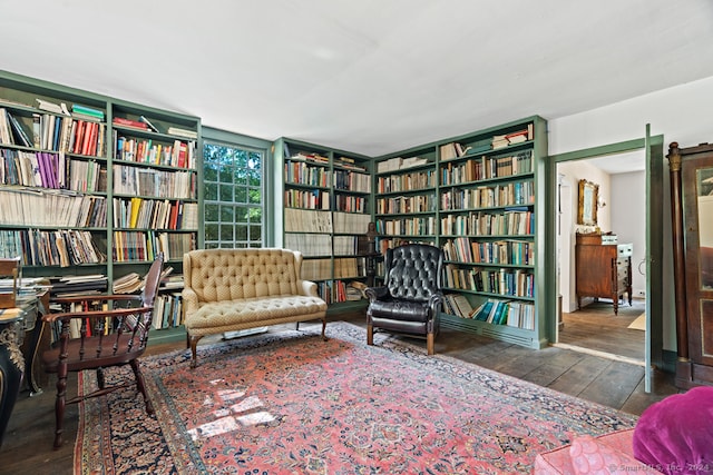 sitting room with dark wood-type flooring