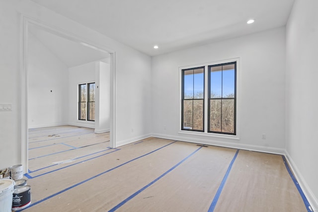 spare room with baseboards and recessed lighting