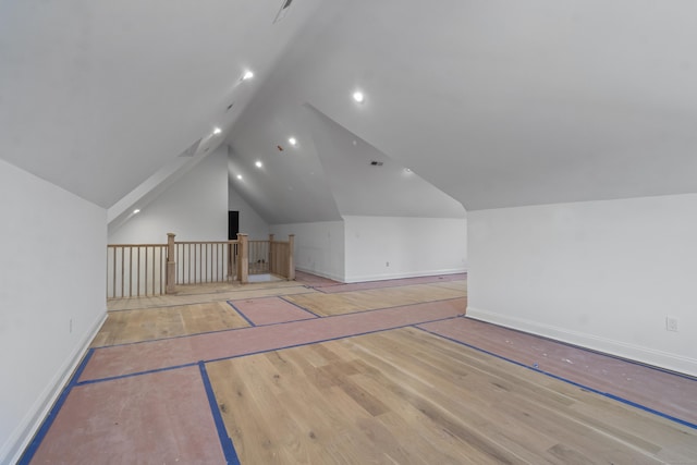 bonus room with lofted ceiling, recessed lighting, light wood-style flooring, and baseboards