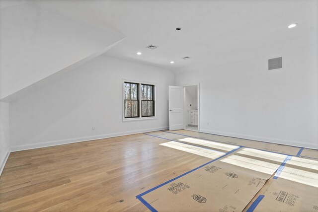 bonus room with light hardwood / wood-style flooring and vaulted ceiling