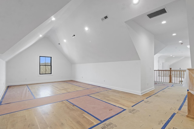 bonus room featuring light hardwood / wood-style flooring and lofted ceiling