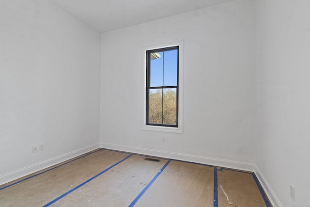 spare room featuring baseboards and visible vents