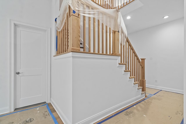 stairs featuring recessed lighting and baseboards