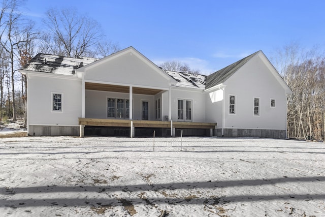 view of snow covered rear of property