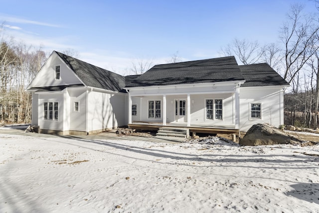 snow covered property featuring a porch