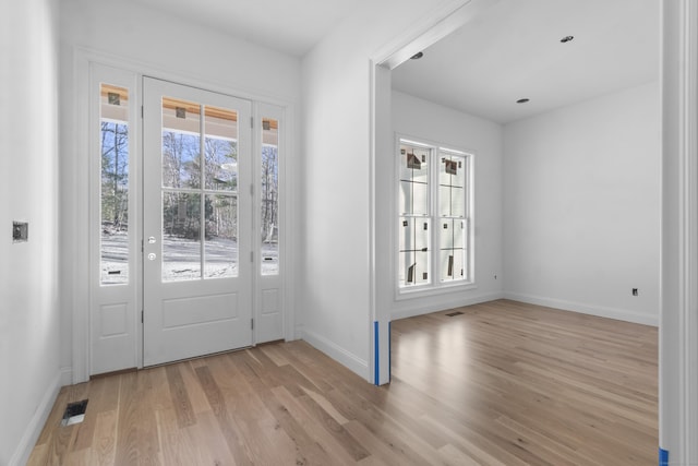 foyer entrance with light hardwood / wood-style floors