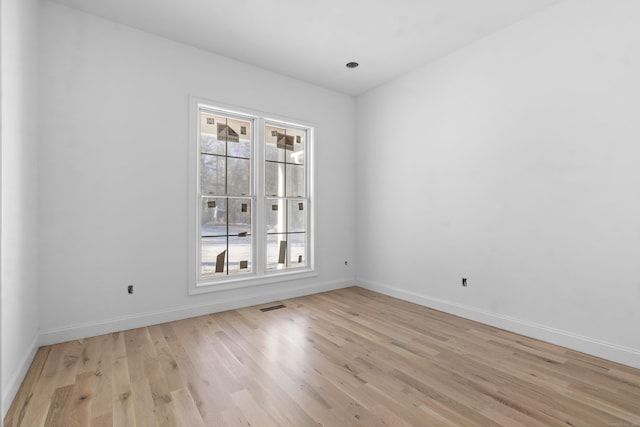 empty room featuring light hardwood / wood-style flooring and a healthy amount of sunlight