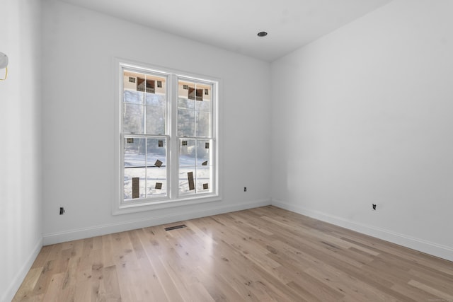 empty room with light hardwood / wood-style flooring