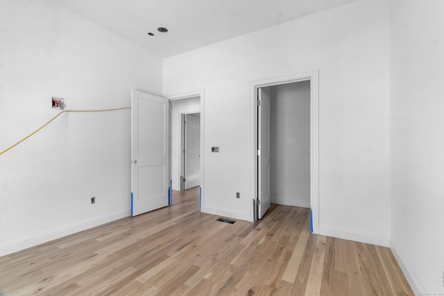 unfurnished bedroom with light wood-type flooring