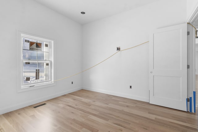 spare room featuring light hardwood / wood-style flooring