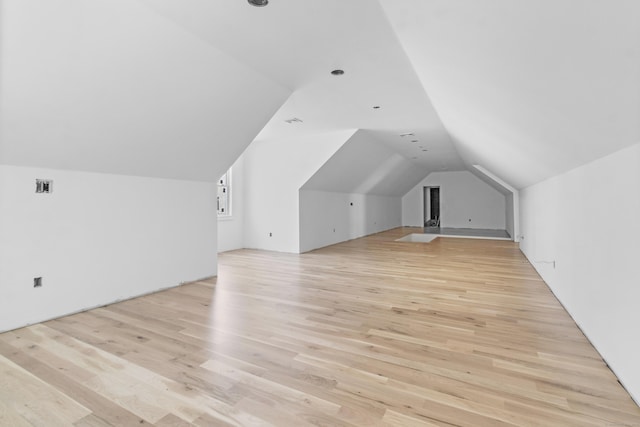 bonus room with light hardwood / wood-style floors and lofted ceiling