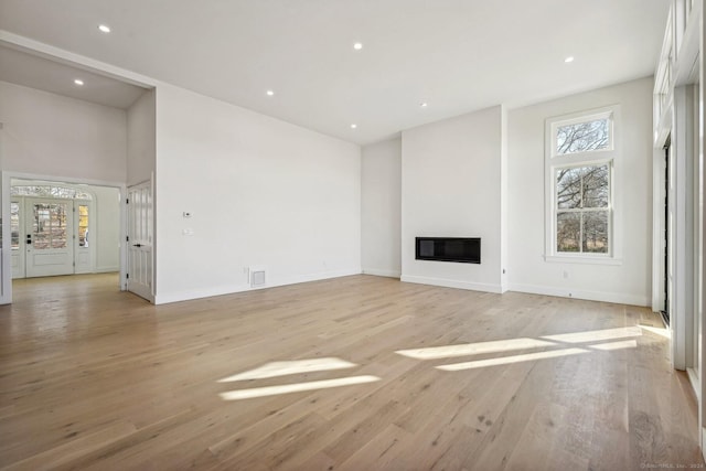 unfurnished living room featuring light hardwood / wood-style flooring