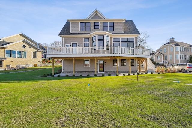 rear view of house with a patio, a deck, and a lawn