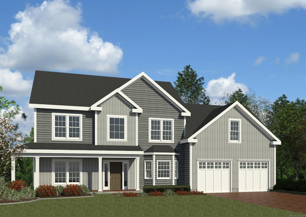 view of front of home with a garage and a front lawn