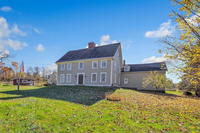 rear view of property with a lawn