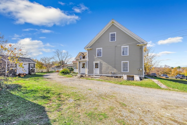 rear view of property with a yard