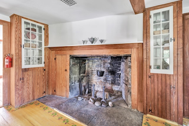 details with hardwood / wood-style floors and wood walls