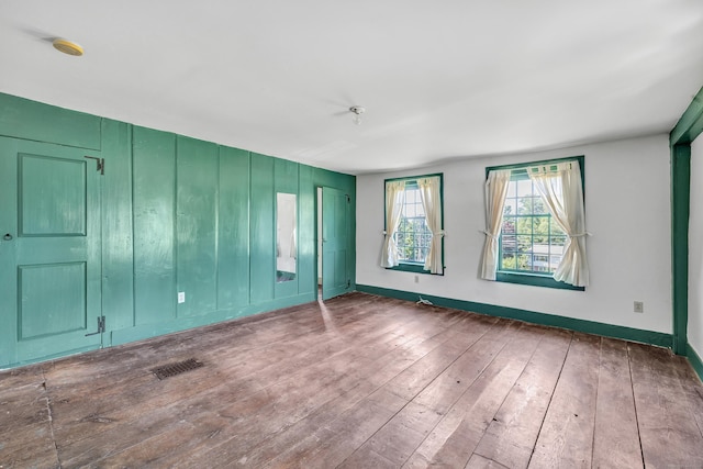 unfurnished room featuring hardwood / wood-style floors