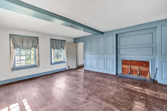 unfurnished living room with beam ceiling and dark wood-type flooring