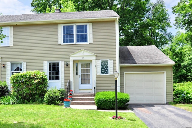29 Early Dawn Cir Unit 29, Windsor, CT 06095 - colonial house with a garage, asphalt driveway, a front lawn, and a chimney