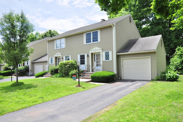 29 Early Dawn Cir Unit 29, Windsor, CT 06095 - colonial house featuring an attached garage, asphalt driveway, a chimney, a front yard, and roof with shingles