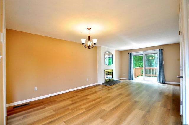 29 Early Dawn Cir Unit 29, Windsor, CT 06095 - unfurnished room featuring a chandelier, light wood-type flooring, and a fireplace