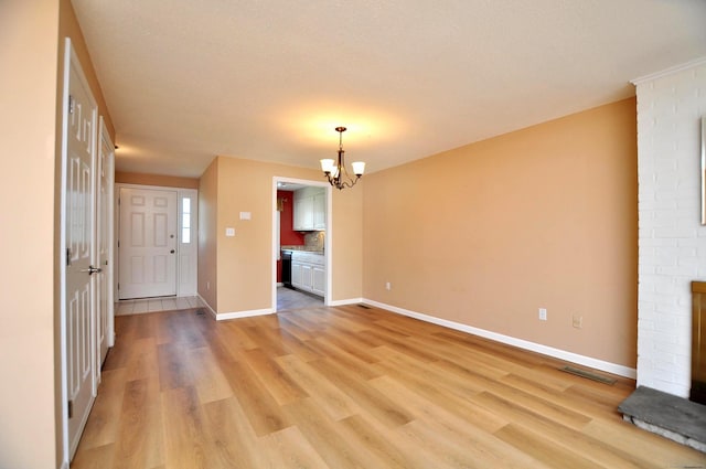 29 Early Dawn Cir Unit 29, Windsor, CT 06095 - empty room with a chandelier and light wood finished floors