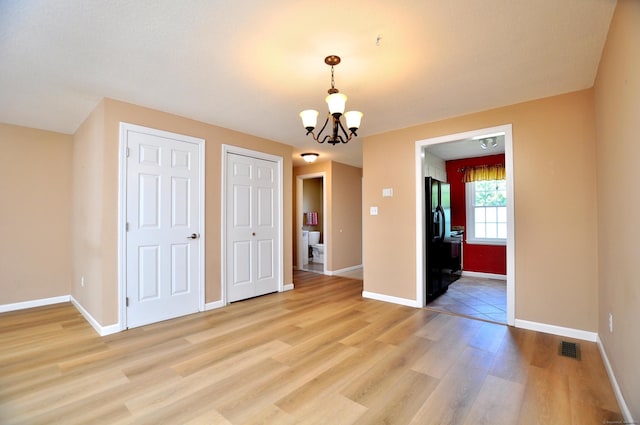 29 Early Dawn Cir Unit 29, Windsor, CT 06095 - unfurnished dining area featuring light wood-style floors and a chandelier