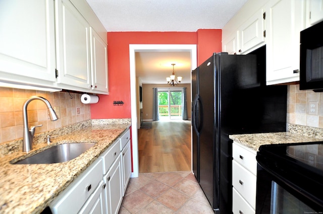 29 Early Dawn Cir Unit 29, Windsor, CT 06095 - kitchen featuring black appliances, white cabinetry, a chandelier, and backsplash