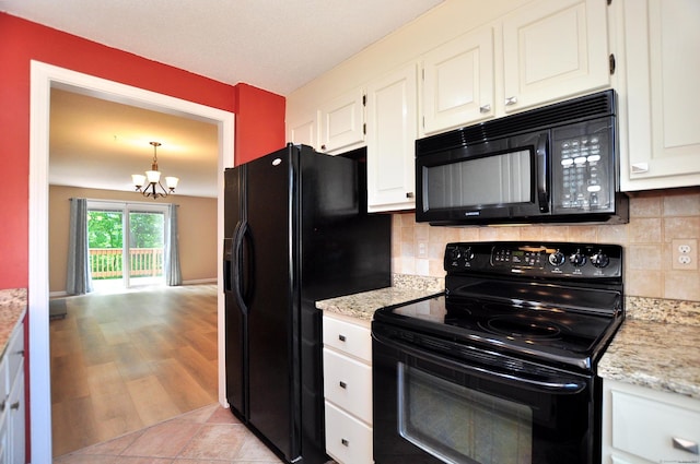29 Early Dawn Cir Unit 29, Windsor, CT 06095 - kitchen with black appliances, a chandelier, white cabinets, tasteful backsplash, and light wood-type flooring