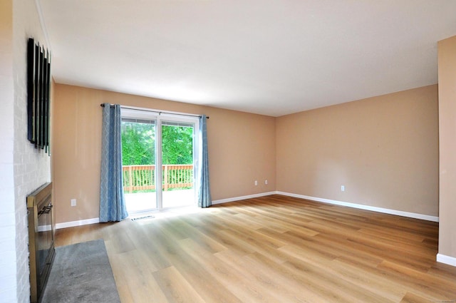 29 Early Dawn Cir Unit 29, Windsor, CT 06095 - spare room with a brick fireplace and light wood-type flooring